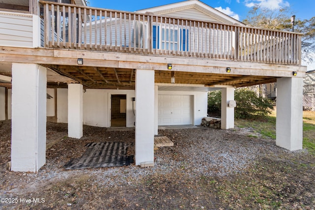 view of patio featuring a garage and a deck