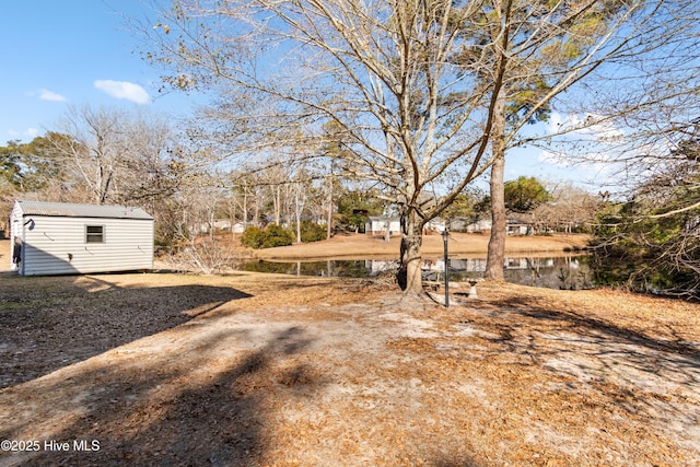 view of yard with a water view and a storage unit