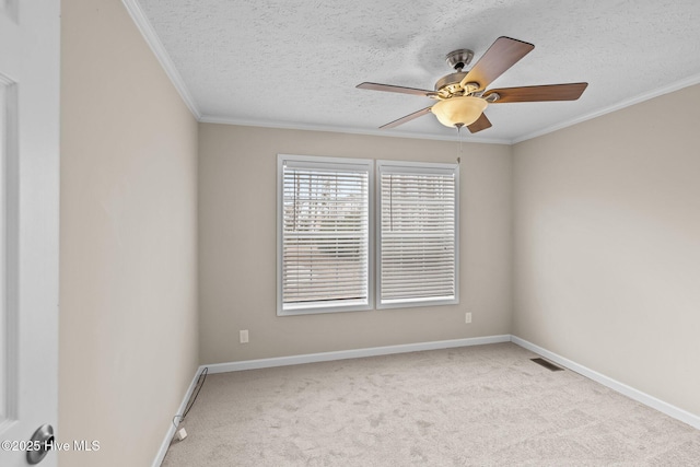 carpeted spare room featuring a textured ceiling, ceiling fan, and ornamental molding