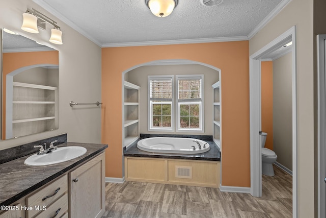 bathroom with a bathtub, toilet, a textured ceiling, and crown molding