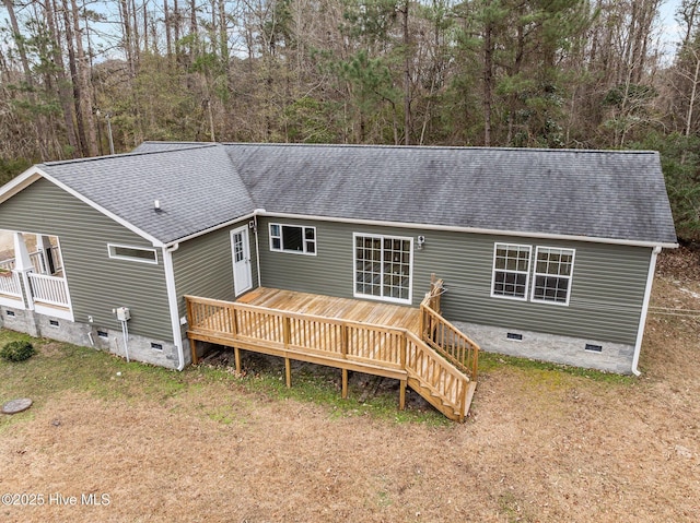 rear view of house featuring a wooden deck