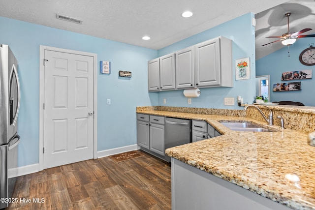 kitchen with dark wood-type flooring, sink, vaulted ceiling, ceiling fan, and appliances with stainless steel finishes