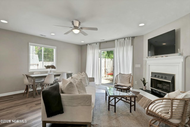 living room featuring hardwood / wood-style flooring and ceiling fan