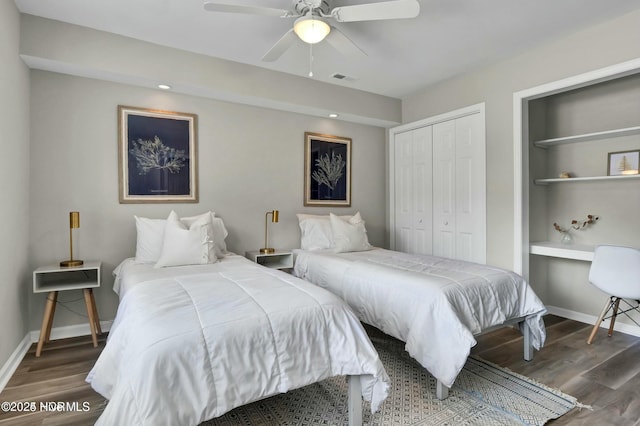 bedroom with dark wood-type flooring, ceiling fan, and a closet