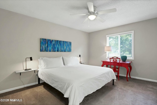 bedroom with ceiling fan, carpet flooring, and a textured ceiling