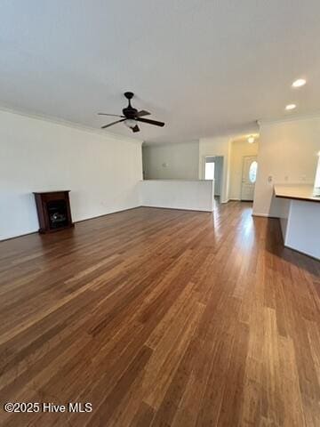 unfurnished living room with ceiling fan, dark hardwood / wood-style flooring, and crown molding