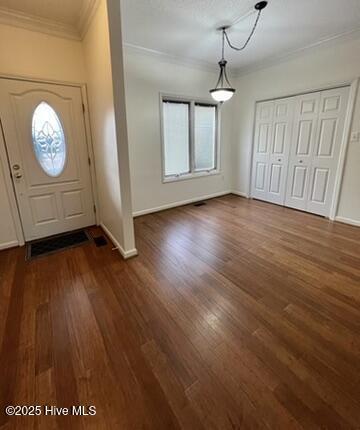 foyer with a textured ceiling and dark wood-type flooring