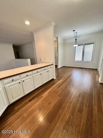 interior space with dark hardwood / wood-style flooring and ornamental molding