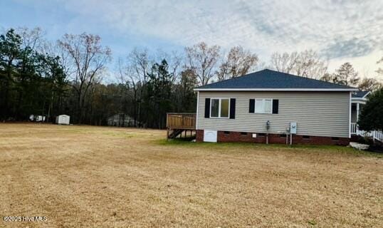 view of side of home featuring a lawn