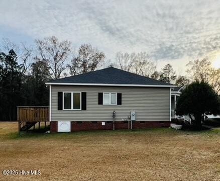 rear view of property with a lawn and a wooden deck