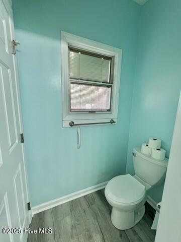 bathroom featuring toilet and wood-type flooring