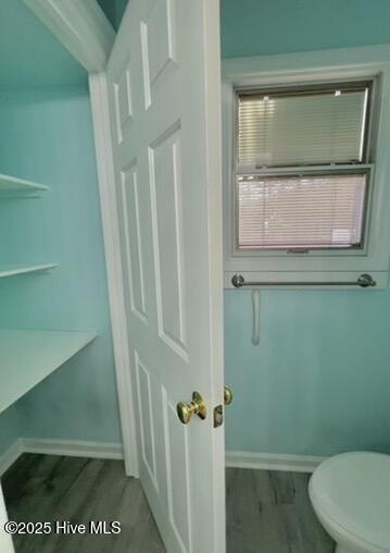 bathroom with toilet and hardwood / wood-style flooring