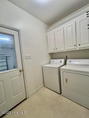 laundry room with cabinets, separate washer and dryer, and a textured ceiling