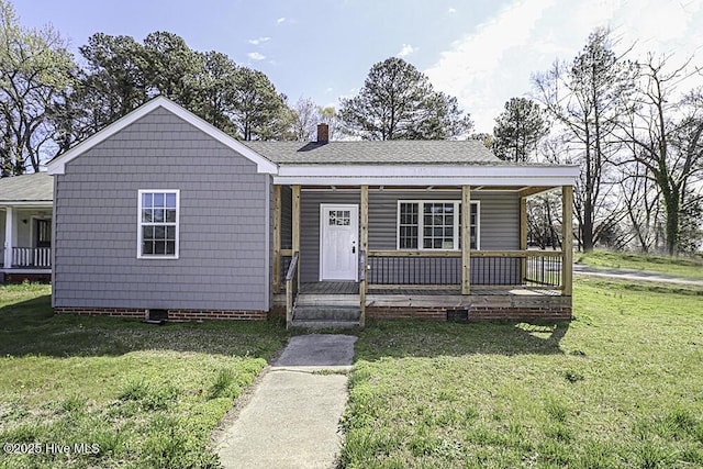 bungalow-style house featuring covered porch and a front yard