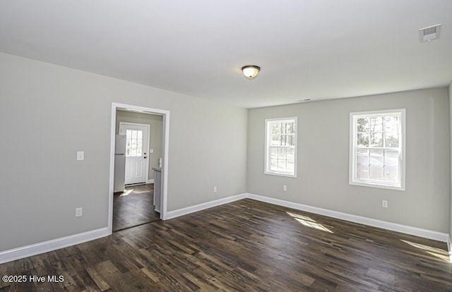 spare room with dark hardwood / wood-style flooring