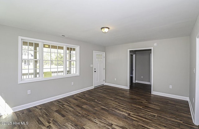 spare room featuring dark hardwood / wood-style flooring