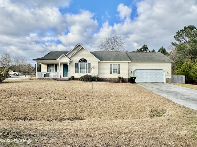 ranch-style house featuring covered porch and a garage