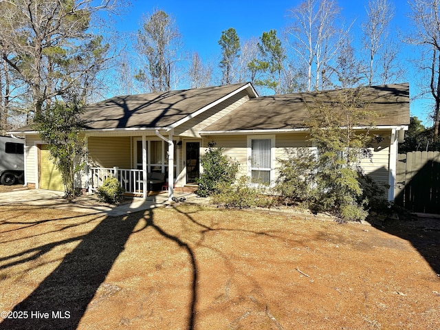 ranch-style home featuring covered porch and a garage