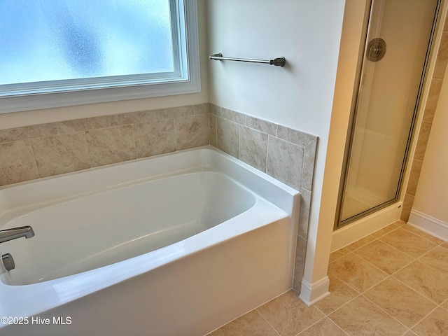 bathroom featuring tile patterned flooring and plus walk in shower