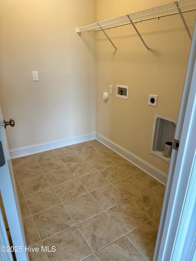 washroom with hookup for an electric dryer, washer hookup, tile patterned flooring, and hookup for a gas dryer