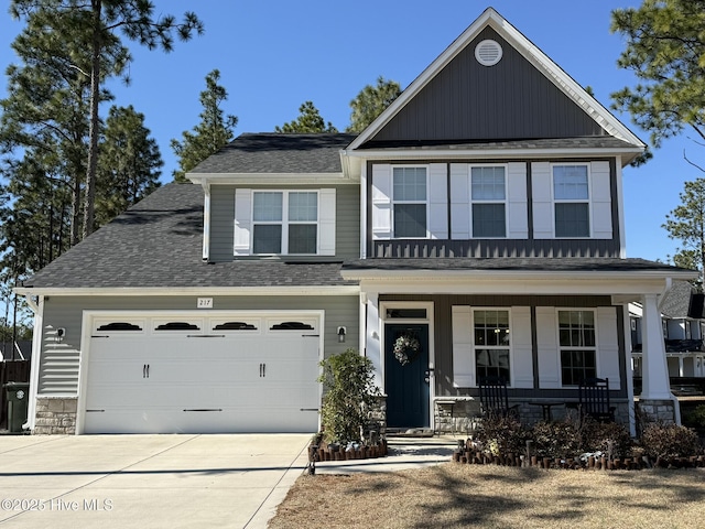 view of front of property featuring a garage and covered porch