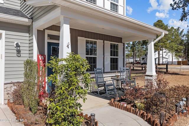 exterior space featuring covered porch and roof with shingles