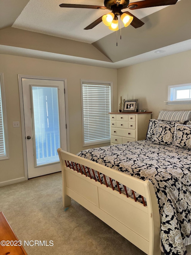 bedroom with ceiling fan, lofted ceiling, and light carpet