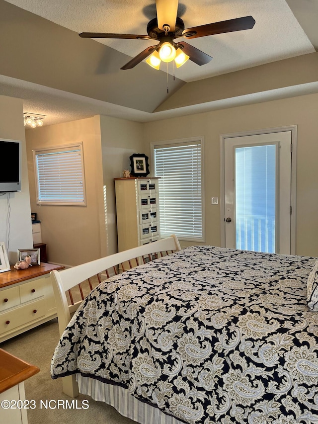 bedroom with ceiling fan, carpet floors, a textured ceiling, and vaulted ceiling