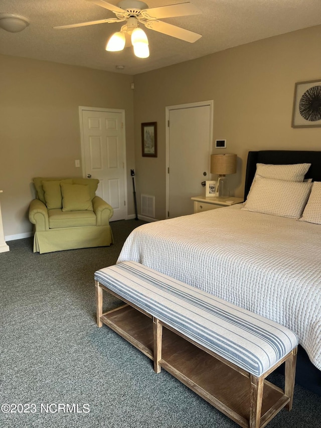 bedroom with carpet, a textured ceiling, and ceiling fan