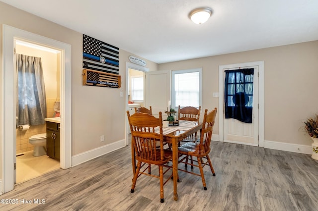 dining area featuring baseboards and wood finished floors