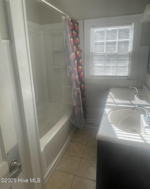 bathroom featuring tile patterned flooring, shower / bath combo, and vanity