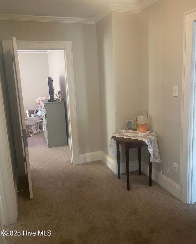 hallway with carpet flooring and ornamental molding