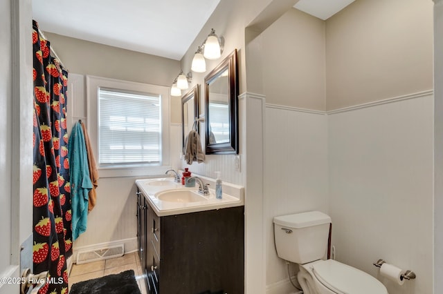 full bath with visible vents, toilet, a sink, tile patterned floors, and double vanity