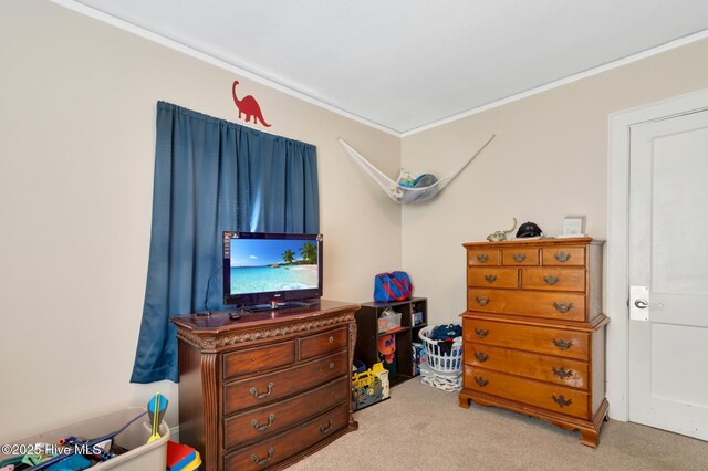 carpeted bedroom with ornamental molding