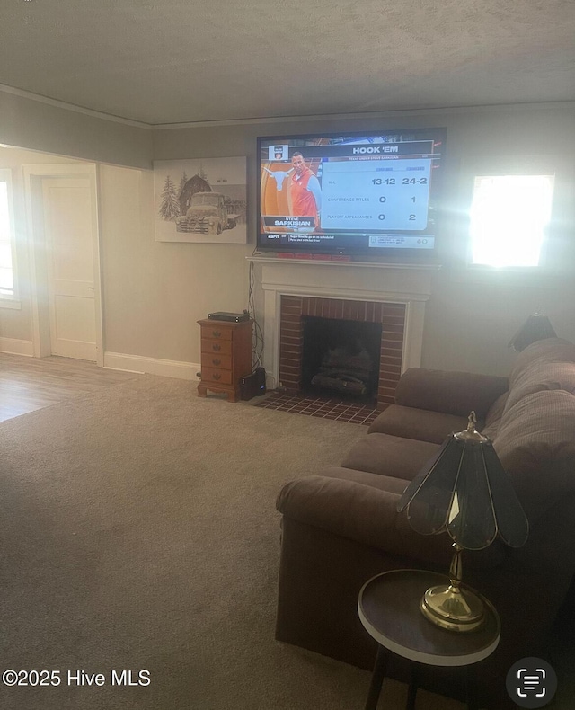 living room featuring carpet flooring, a textured ceiling, and a brick fireplace