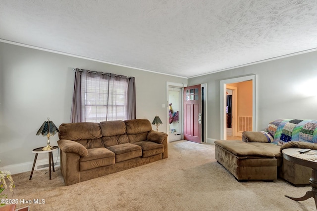 carpeted living area featuring baseboards, a textured ceiling, crown molding, and visible vents