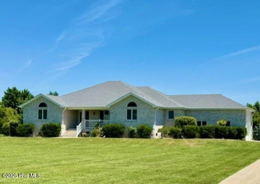 ranch-style house with a porch and a front lawn