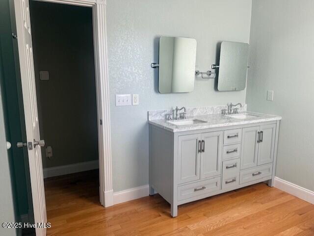 bathroom featuring hardwood / wood-style flooring and vanity