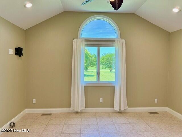 unfurnished room featuring ceiling fan and lofted ceiling