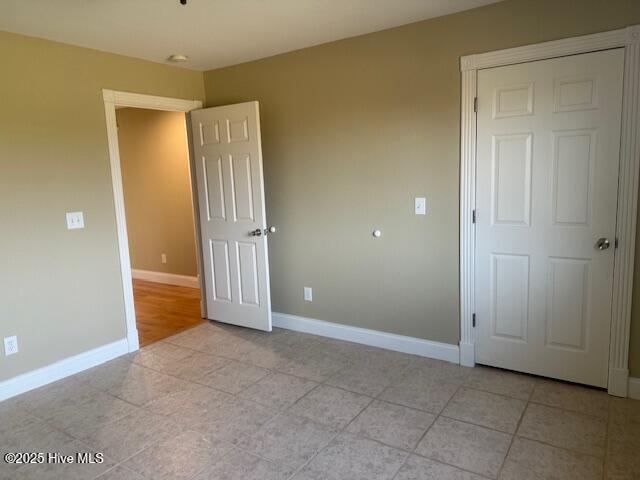 unfurnished bedroom with light tile patterned flooring