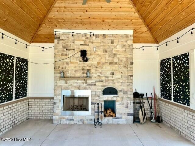 view of patio / terrace featuring an outdoor stone fireplace and a gazebo