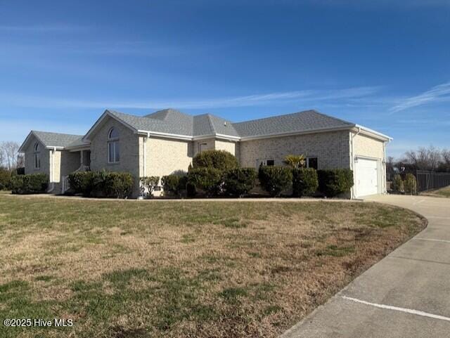 view of side of home with a lawn and a garage