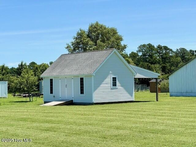 rear view of property with a yard