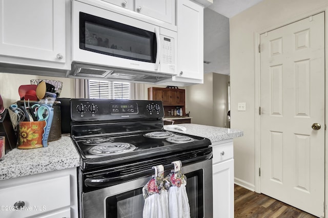 kitchen featuring dark hardwood / wood-style floors, white cabinetry, and electric stove