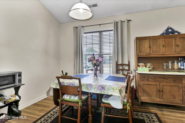 dining area featuring dark hardwood / wood-style flooring