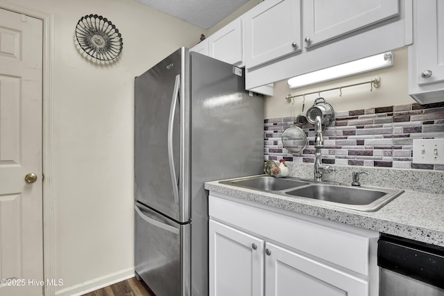 kitchen with sink, decorative backsplash, dark hardwood / wood-style floors, white cabinetry, and stainless steel appliances