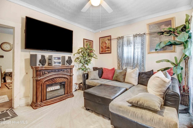 carpeted living room with ornamental molding and ceiling fan