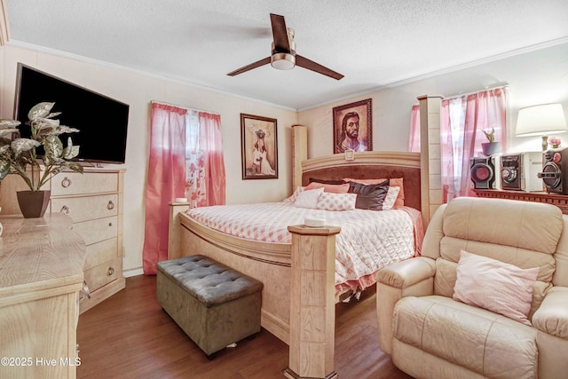 bedroom featuring a textured ceiling, ceiling fan, crown molding, and hardwood / wood-style floors