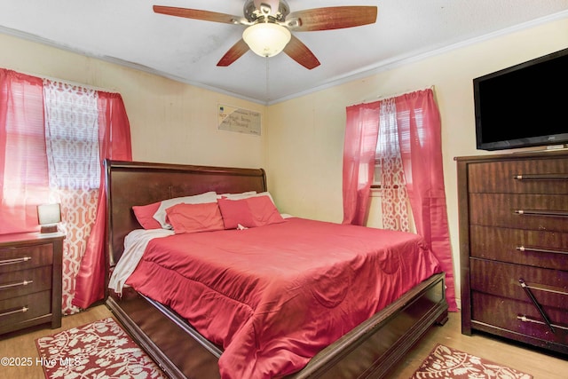 bedroom with ornamental molding, light wood-type flooring, ceiling fan, and multiple windows