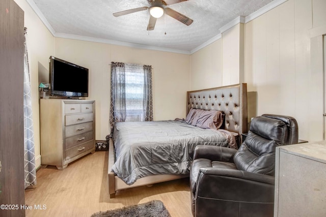 bedroom featuring ceiling fan, light hardwood / wood-style floors, crown molding, and a textured ceiling